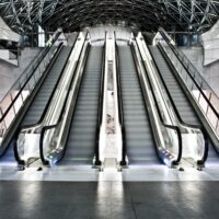 An interior shot of a building with escalators