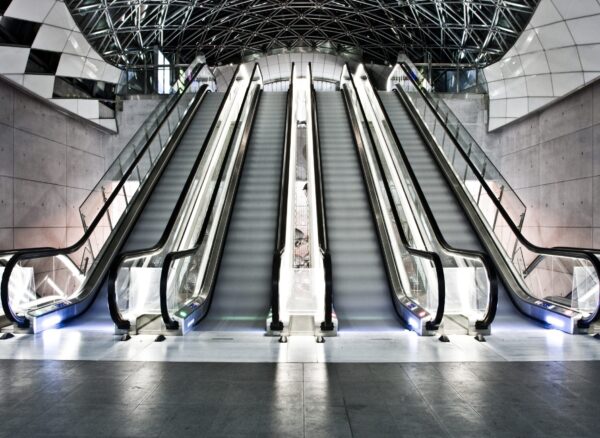 An interior shot of a building with escalators